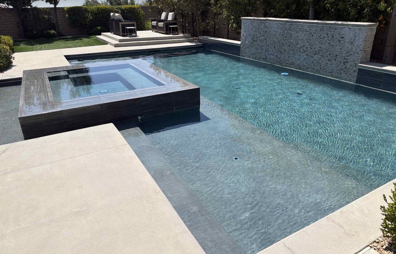 Modern pool and raised spa with clear, professionally balanced water