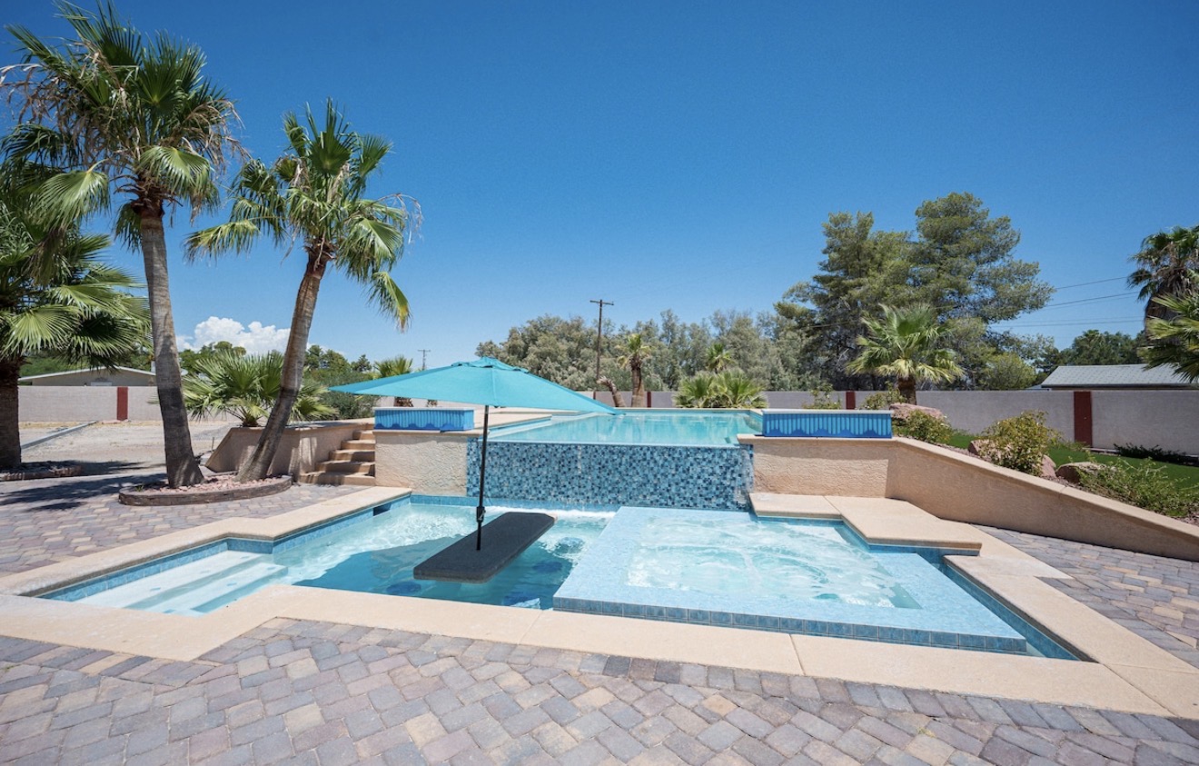 Resort-style Las Vegas pool with raised spa and waterfall